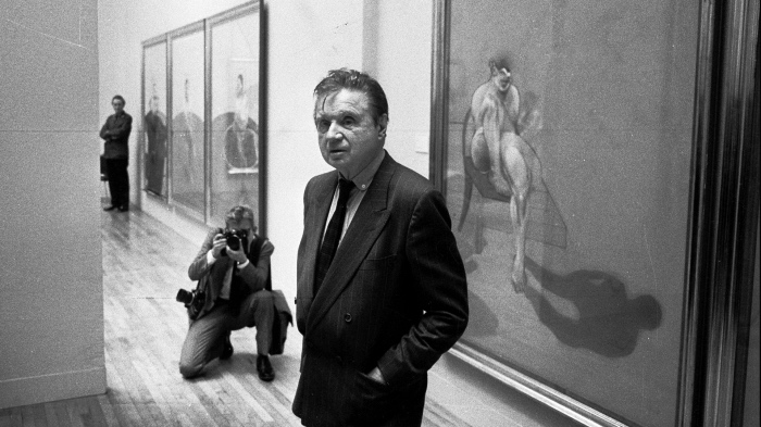 Artist Francis Bacon in front of the left panel of his 'Triptych' (1983) at his Tate Gallery show, 1985. (Photo by Michael Ward/Getty Images)